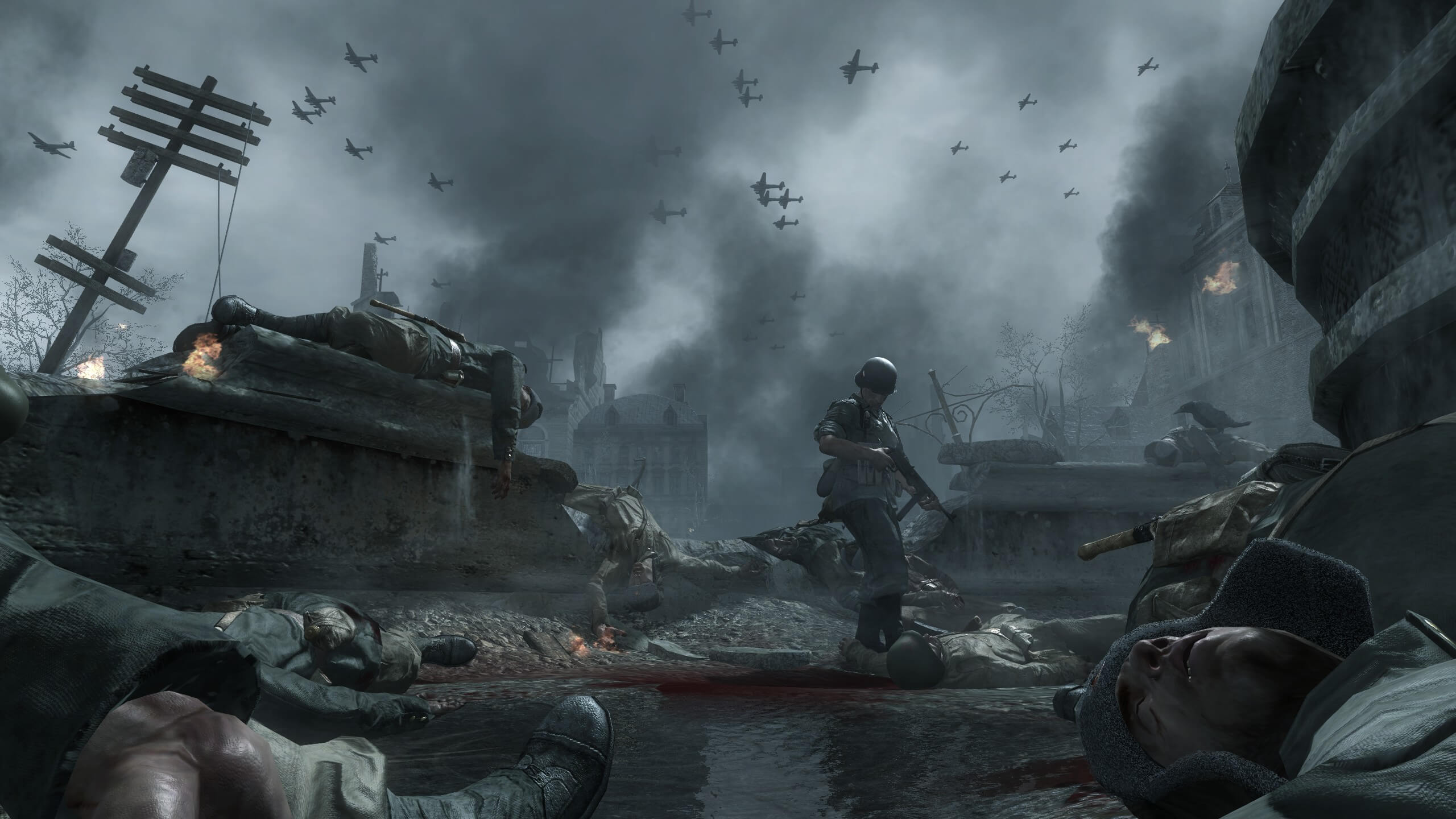 A fountain in the city of Stalingrad. There are a few dead Russian soldiers laying on the ground and a German solider walking across checking for any survivors.