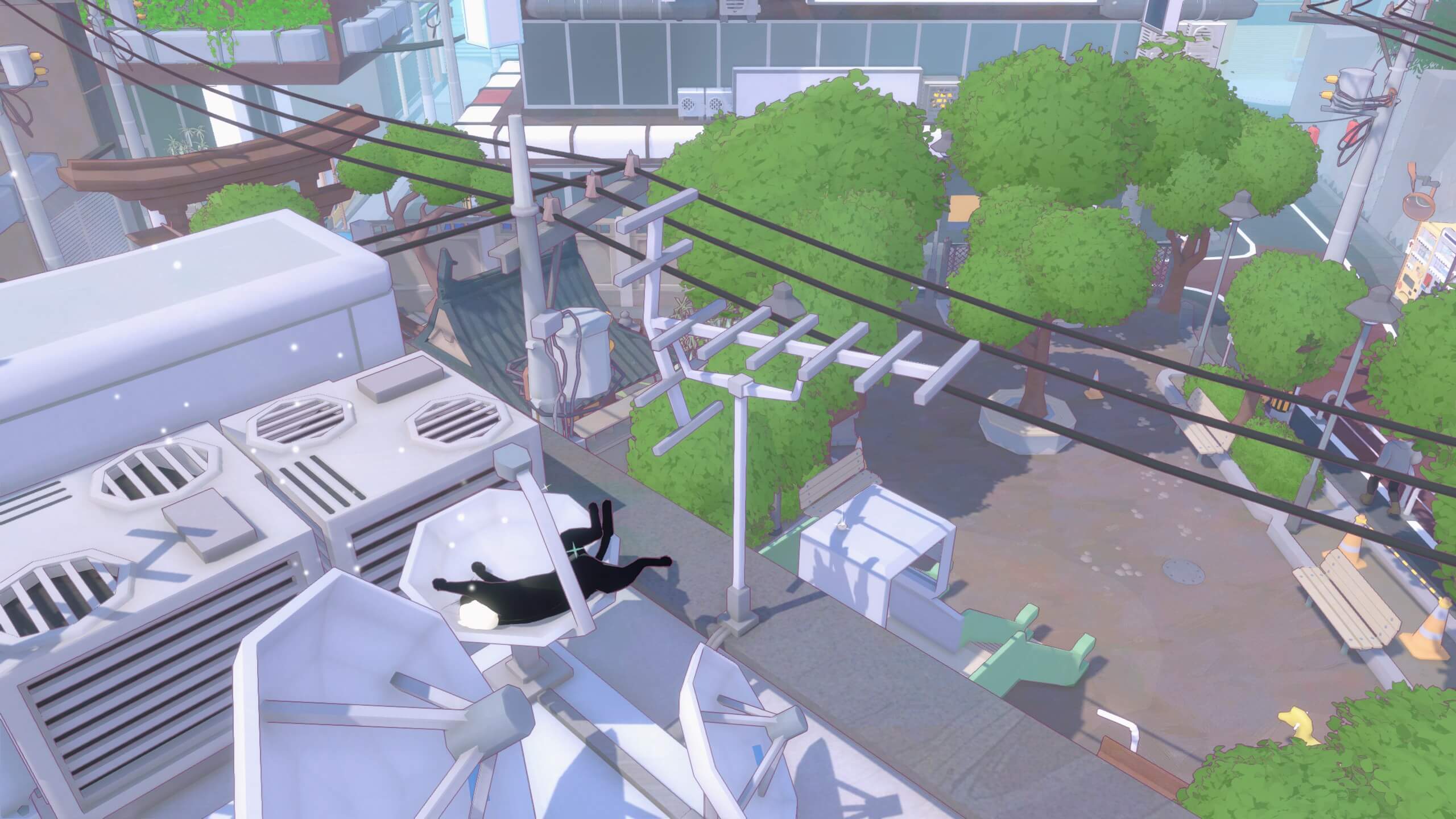 The kitty is taking a nap inside a small satellite dish on a building room overlooking a playground with a slide.